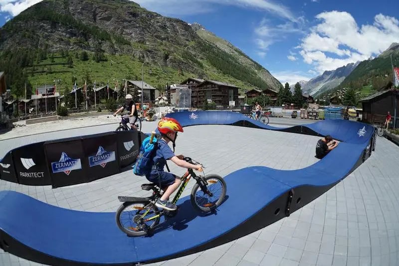 Pumptracks increase access to mountain biking. A PARKITECT modular pumptrack in Zermatt at the foot of the Matterhorn.