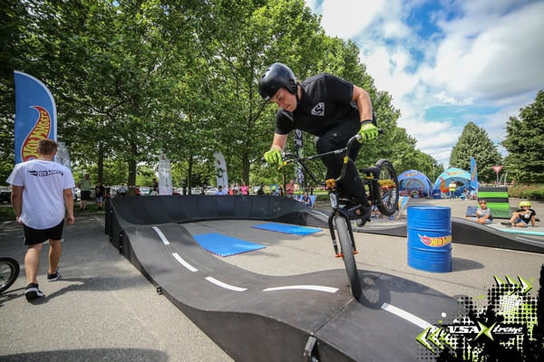 A biker performs a trick on one of our modular pumptracks at an event sponsored by Hot Wheels and produced by VSA Xtreme