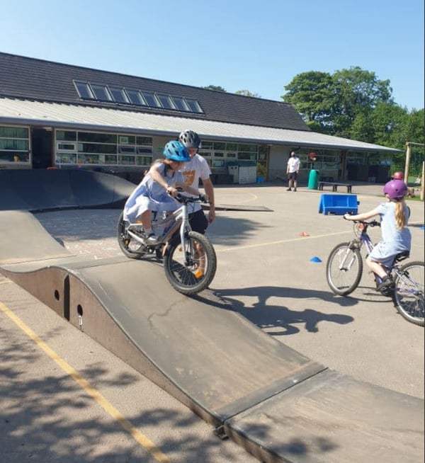 A young girl rides the modular pumptrack rented from Dirt Factory at her school