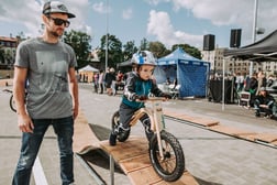 A younster (or future pro) tries out the wooden skills course next to the pumptrack at center sports square in Riga, Latvia