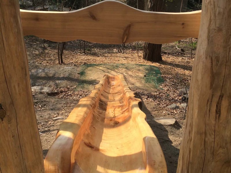 A hollowed out log is a slide at the natural playground found at Ontario Science Center in Toronto, Ontario.