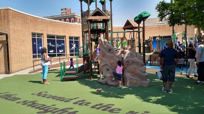 Children play at a playground inspired by Peter Pan at Elmwood Park, a themed playground installed by the City of Roanoke, Virginia.
