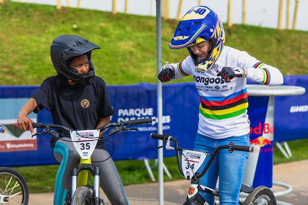 Racers Khothalang Leuta and Payton Ridenour share riding techniques while warming up for Red Bull UCI World Championships in Lisbon, Portugal.