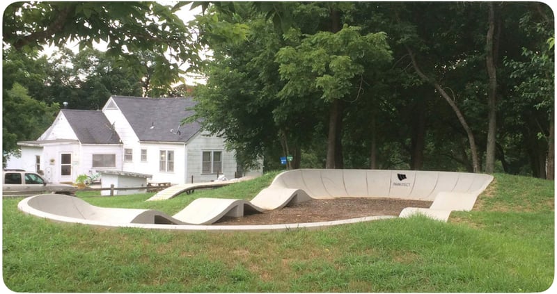 PARKITECT modular pumptrack made of precast concrete, incorporated in the landscape in 
