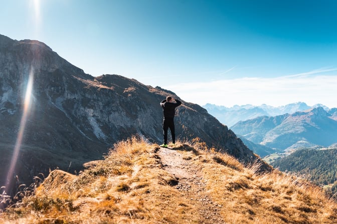 man-standing-on-a-mountain-and-looking-out-over-the-scenery-picjumbo-com-1