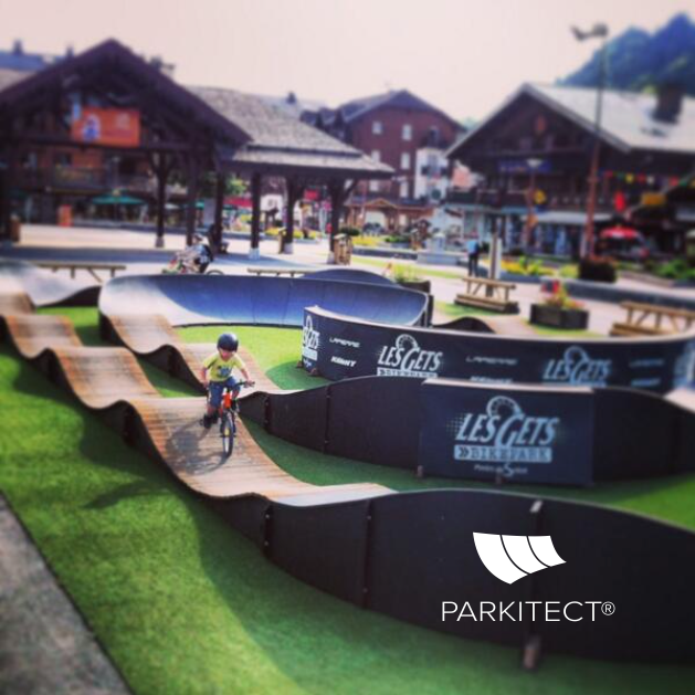 Child enjoying PARKITECTs modular pumptrack at the French alpine resort Les Gets